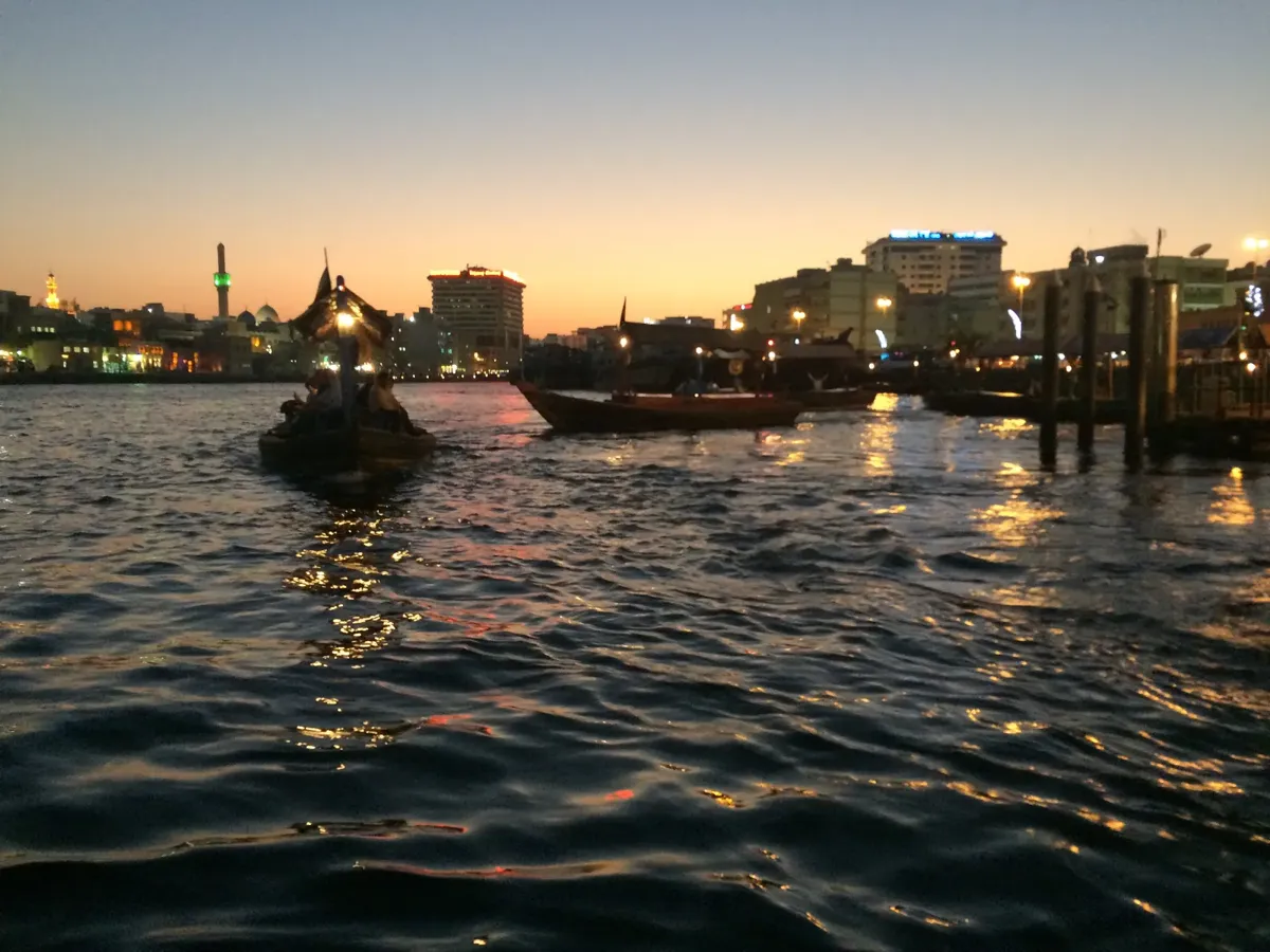 An abra on Dubai Creek at dusk